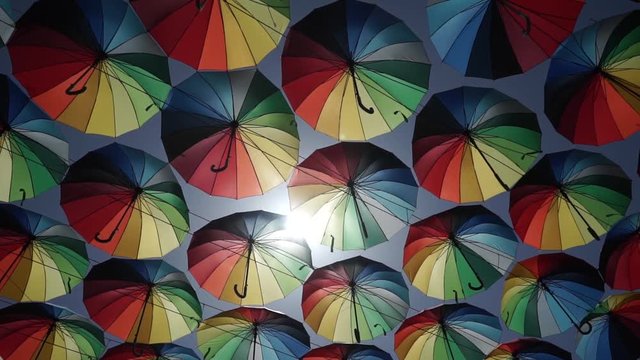 Street decorated with canopy of colorful umbrellas.  colorful canopy of umbrellas