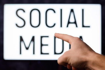 Man pointing to a screen with inscription SOCIAL MEDIA