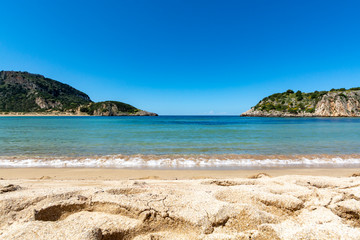 Voidokilia Beach, popular white sand and blue clear water beach in Messinia in Mediterranean area in shape of Greek letter omega, Peloponnese, Greece.