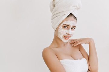 Portrait of beautiful young woman with towels after take bath make cosmetic mask on her face. Rejuvenation,cosmetology, hydration, spa and care face.Clean and perfect skin. Healthy body.Place for text