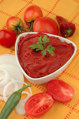 Delicious pasta with ingredients for cooking on an orange background