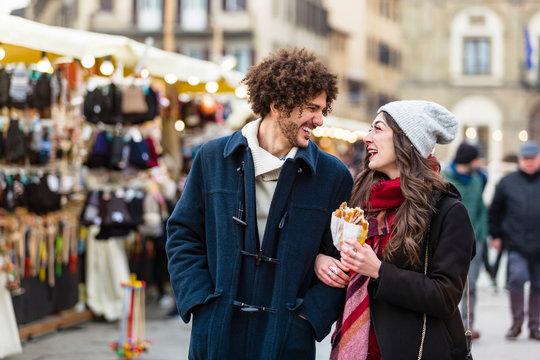 Happy young couple strolling at Christmas market