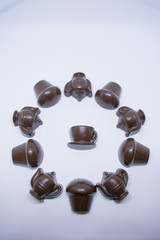 handmade chocolates sweets in the shape of cups, cake and teapot on white background