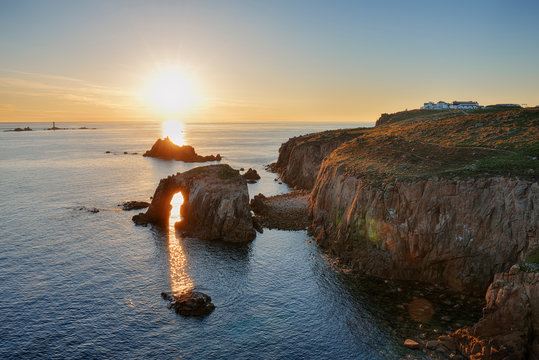 United Kingdom, England, Cornwall, Land's End, Natural Arche and Armed Knight at sunset