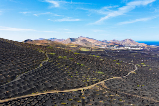 Spain, Canary Islands, Lanzarote, wine growing area La Geria villages Uga and Yaiza, Ajaches mountains, aerial view