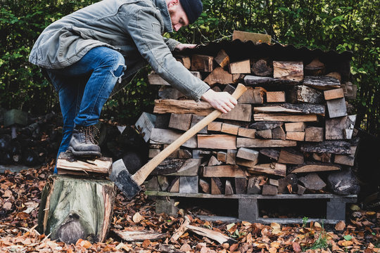 Man using axe to chop firewood