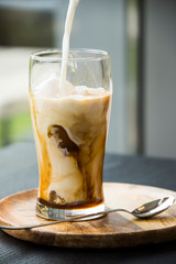 Ice frappuccino on cafe bar tabletop. Trendy coffee specialities.