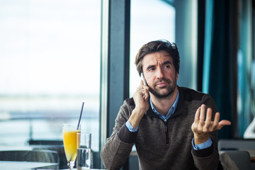 Negative reaction of businessman while talking on the phone