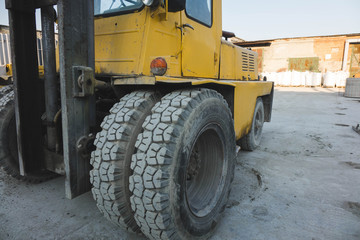 big spiked wheels of yellow tractor durable rubber tires