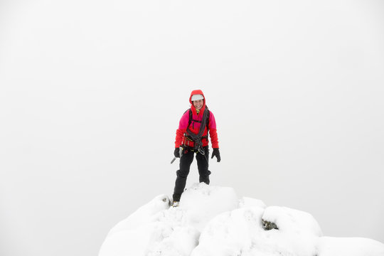 UK, Scotland, Glen Spean, woman on peak of Beinn a Caorainn in winter