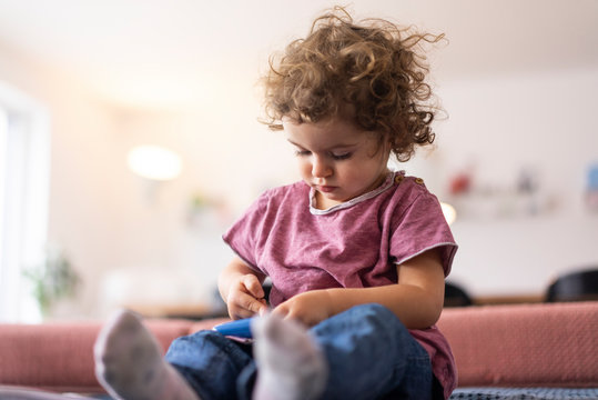 Little girl playing in living room