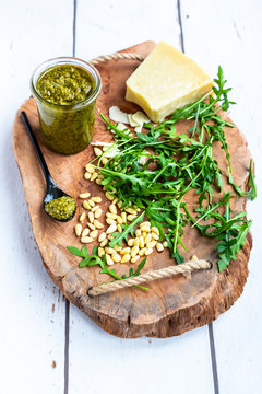 Homemade rocket pesto, rocket, pine nuts, parmesan and rocket on chopping board