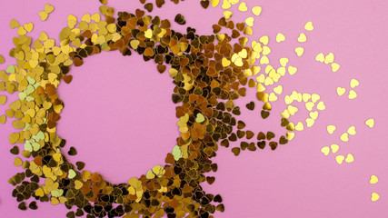 heart-shaped confetti scattered on a pink background. Celebration and party, concept. Copy space
