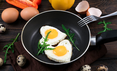 Fried eggs in the form of a heart in a skillet