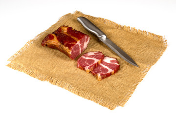 Smoked meat on a white background lying on a beautiful napkin