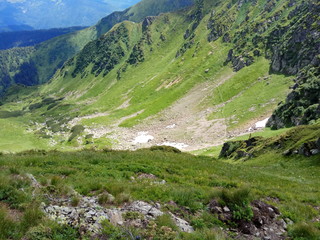 Fototapeta na wymiar snow in the valley in the mountains in the summer