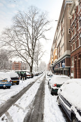 Snow-covered street Hugo de Grootkade in Amsterdam during a cold winter in the Netherlands. Hugo de...