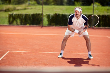 Male tennis player on tennis court