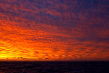 Fototapeta na wymiar Stunning red colored sunset in the Southern Atlantic Ocean