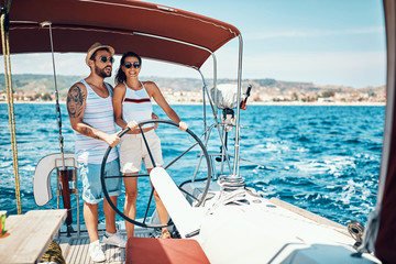 Couple in love on a sail boat in the summer.