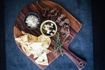 Mediterranean Charcuterie Board with Pita Bread, Olives, Cheese, and Crackers
