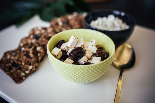 Green Bowl of Olives and Cheese on Charcuterie Board - Powered by Adobe