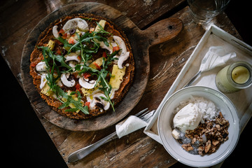 Raw vegan pizza on wooden table