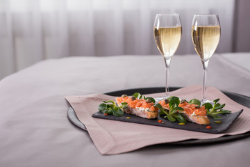 Romantic evening in an interior with a glass of a champagne.