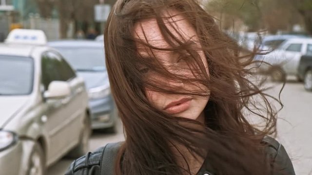 Girl in windy day with her face covered with her long hair