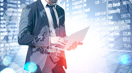 Man with laptop analysing stock exchange data