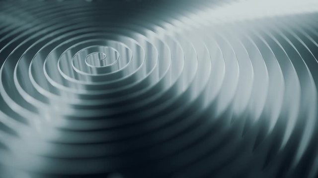 Rotating grey coil, shallow focus. Loopable motion background