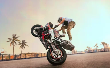 Foto op Plexiglas Moto rider making a stunt on his motorbike. Biker doing a difficult and dangerous stunt. © VIAR PRO studio