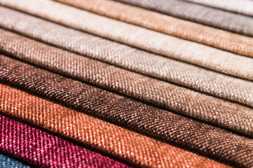 Close-up diagonal lines of textile upholstery in samples to select the color and fabric of the...