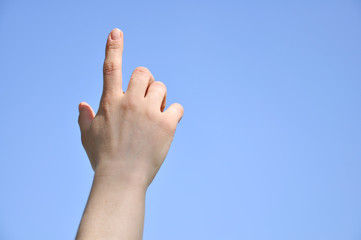 Index finger raised up. Man's hand is directed to the sky