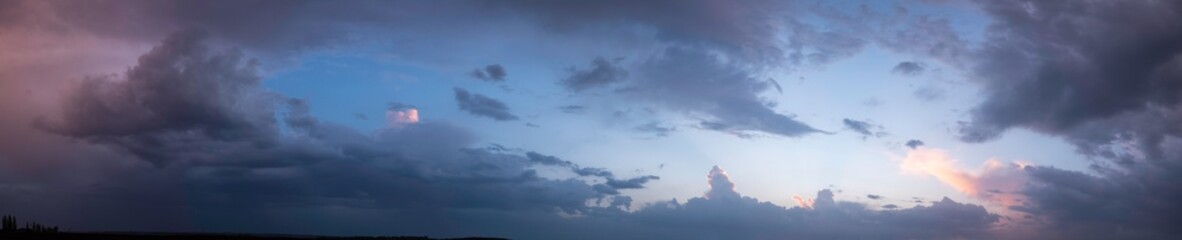 Naklejka na ściany i meble clouds at sunset, evening time. Panorama
