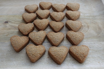Organic homemade heart biscuits on a wooden board