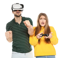 Man wearing VR headset and woman with controller playing video games isolated on white © New Africa