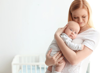 Happy mother and her baby at home