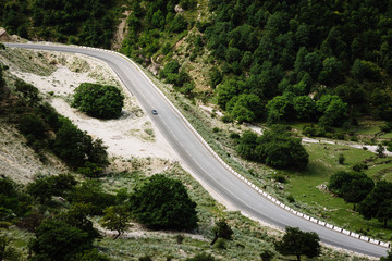 The car goes on a road in the mountains in summer. Sulak Canyon, Dagestan