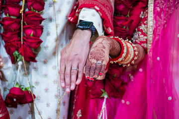 Fototapeta na wymiar Indian wedding rings and ring exchange close up
