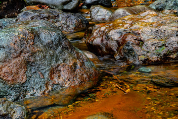 Transparent, calm and clean water of a river with rocks and stones.