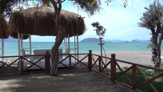 4K Zoom out a cross and beautiful sea view with empty modern beach