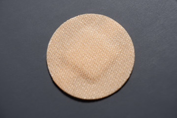 A small round protective bandage for a cut or bleeding