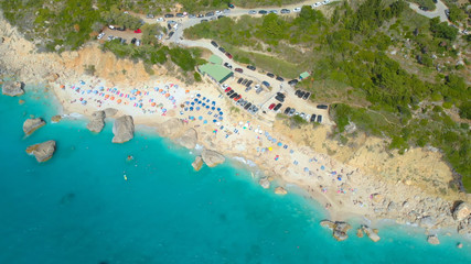 AERIAL: Tourists enjoying their summer vacation on the scenic beach on Lefkada.
