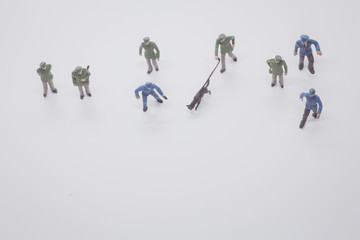 Miniature people  police officer with police dogs have to sniff the evidence to do their job on white background