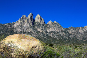 Fototapeta na wymiar A colorful rock sets off Organ Mountains-Desert Peaks National Monument in New Mexico