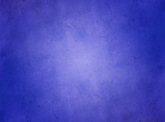 An elegant, dark blue, grunge parchment texture background with glowing center. 