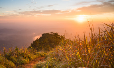 Gold Sunset Light Phu Nom at Phu Langka National Park Thailand with Fog on Sky Wide