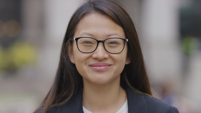 Portrait of smiling young Asian professional looking to camera 