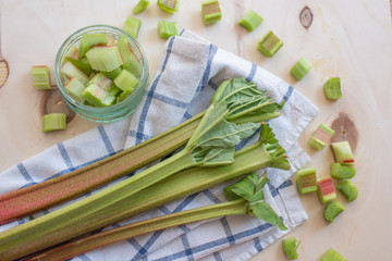 rhubarb stalks on a wooden chopping board
